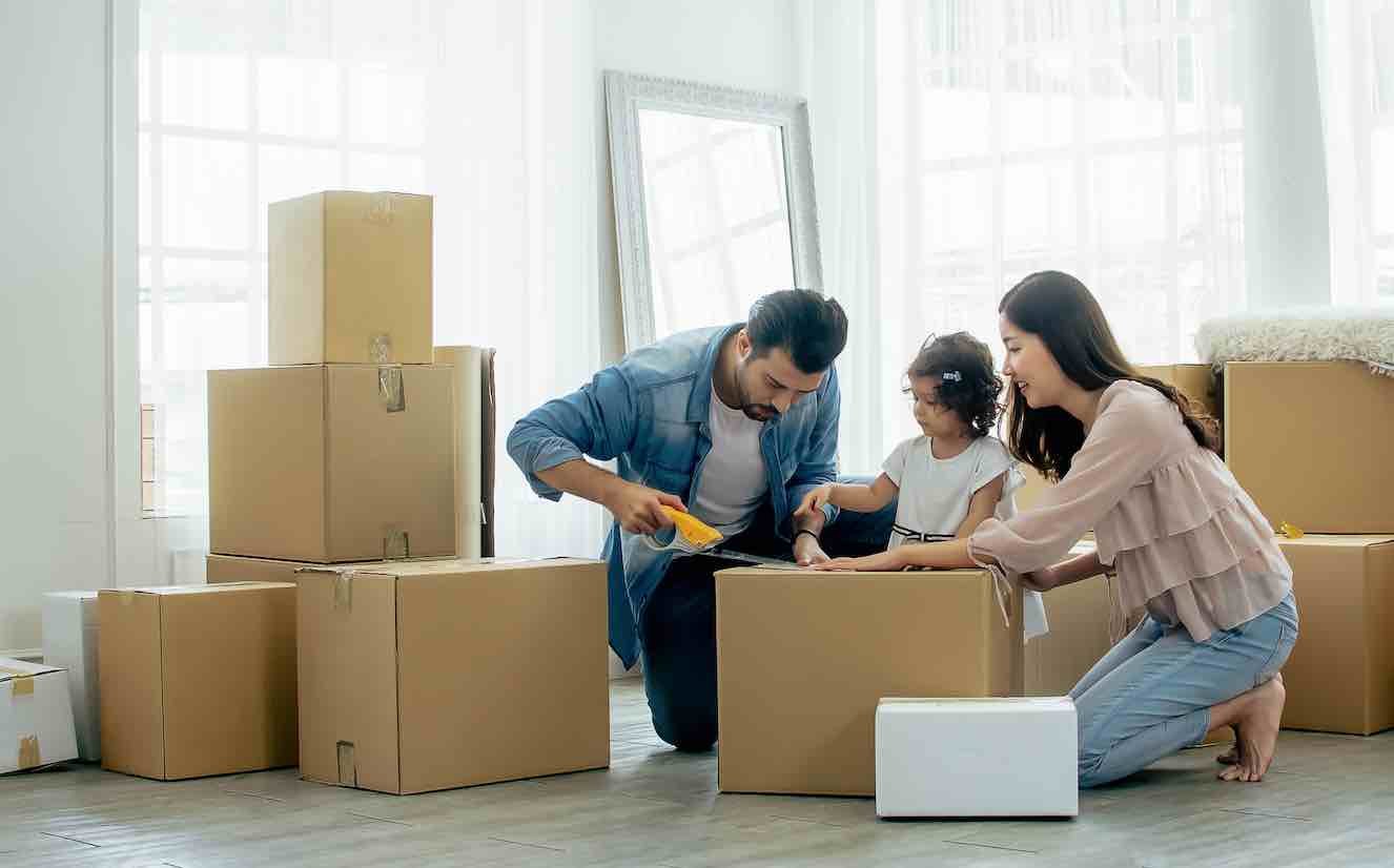 family-moving-into-house-boxes